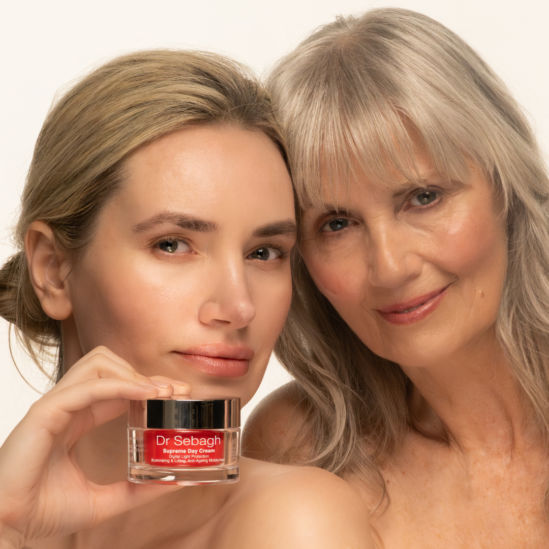 Two women holding a jar of Dr Sebagh Supreme Day Cream against a white background