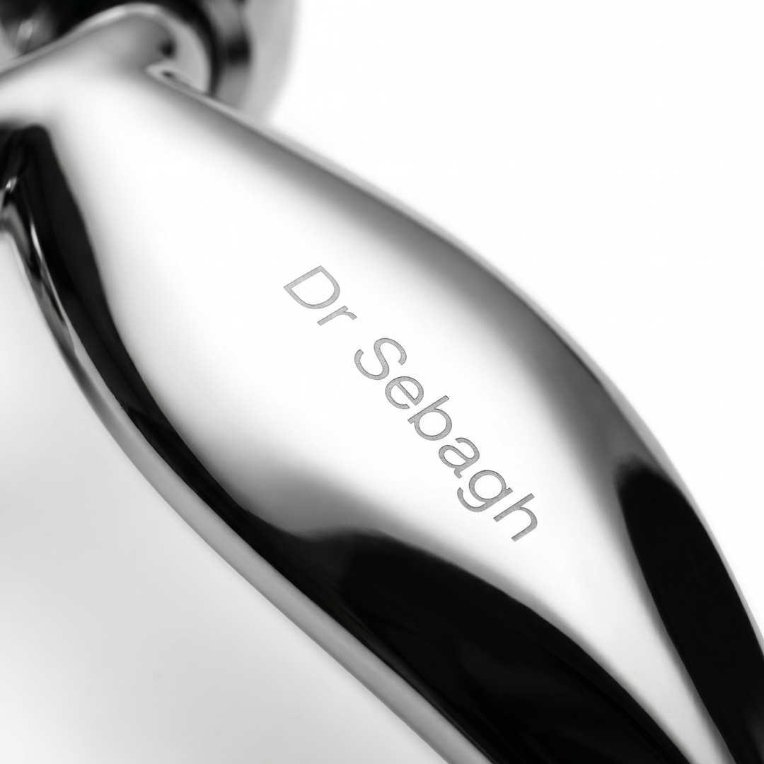Close-up of a silver product with 'Dr Sebagh' engraving on a white background
