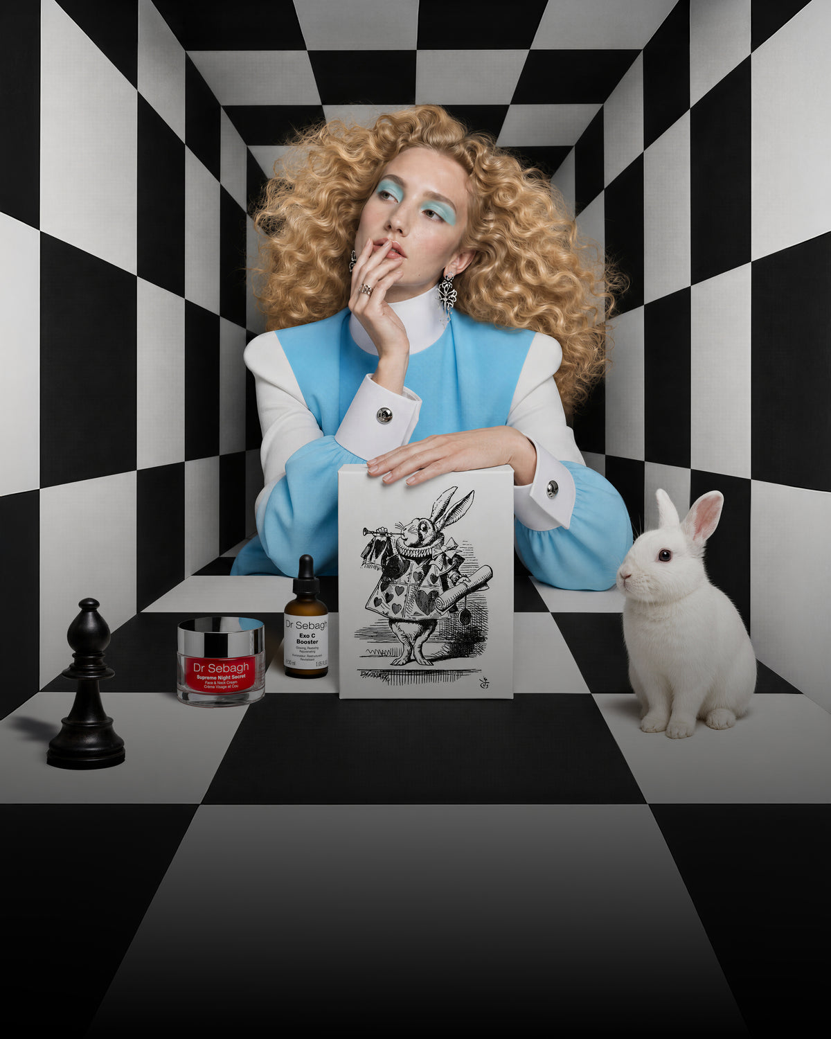 Dr Sebagh Alice in Wonderland Christmas gift box with a White Rabbit lid, shown with a model in a black and white checkerboard room
