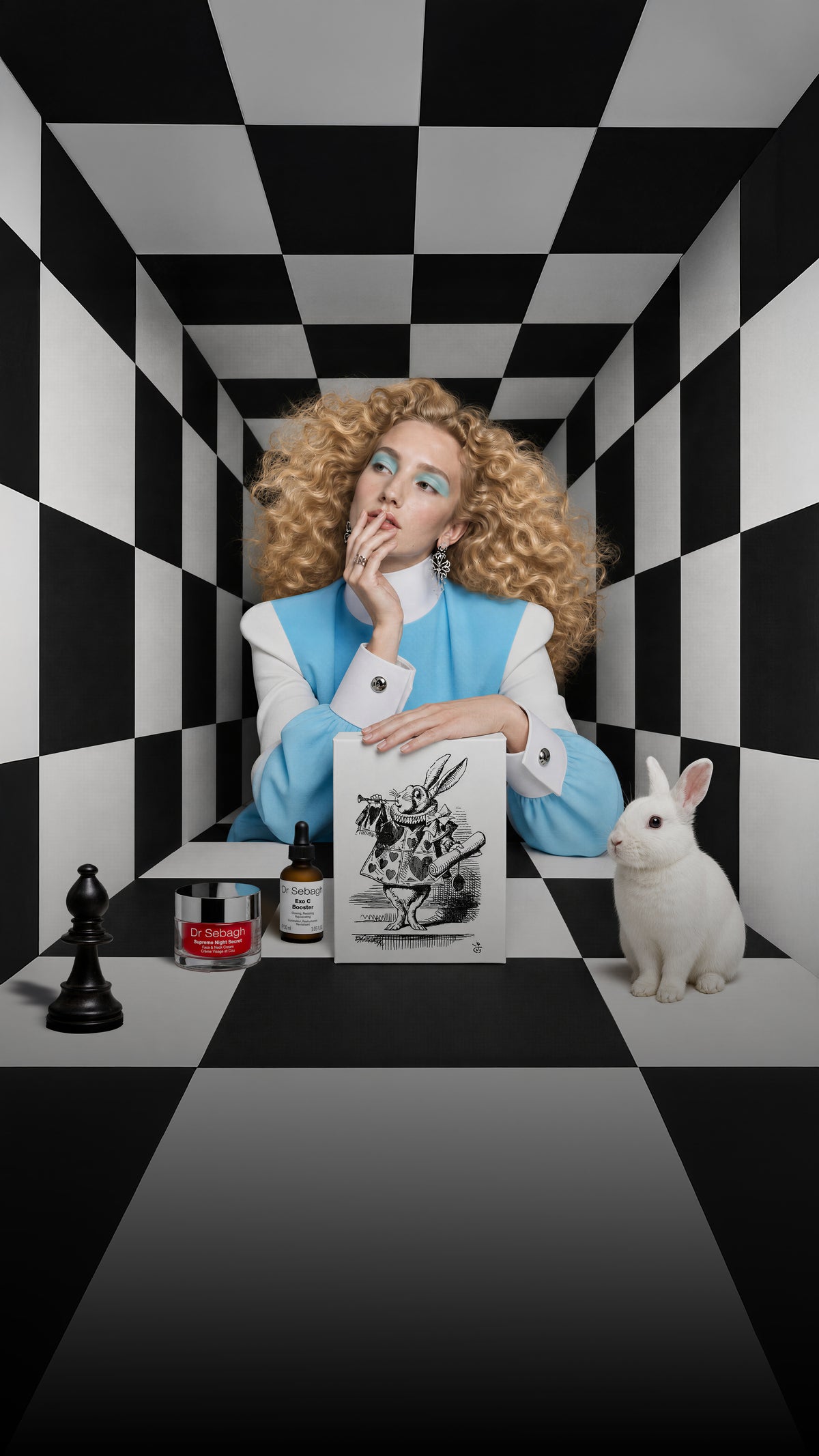 Dr Sebagh Alice in Wonderland Christmas gift box with a White Rabbit lid, shown with a model in a black and white checkerboard room