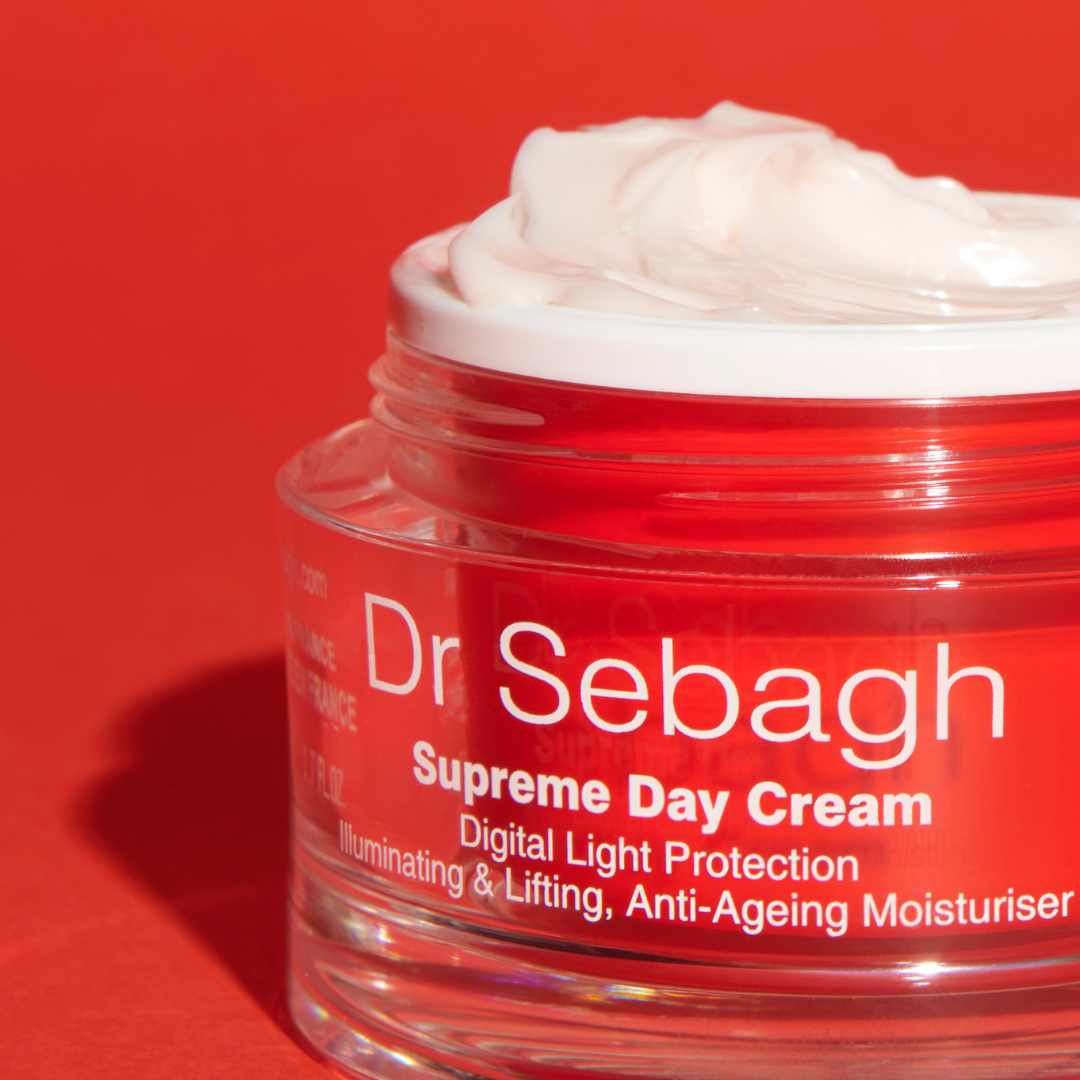 Dr Sebagh Supreme Day Cream jar with cream on a red background
