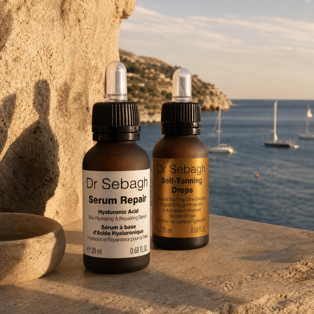 Two Dr Sebagh skincare bottles by a scenic coastal background with boats and mountains.