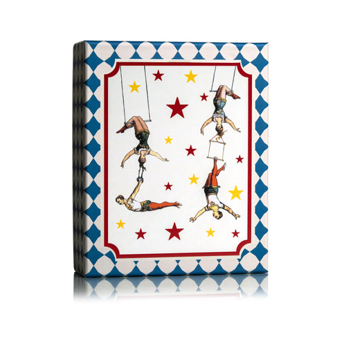 Dr Sebagh Christmas gift box with a blue harlequin border and vintage circus trapeze artists among red and yellow stars