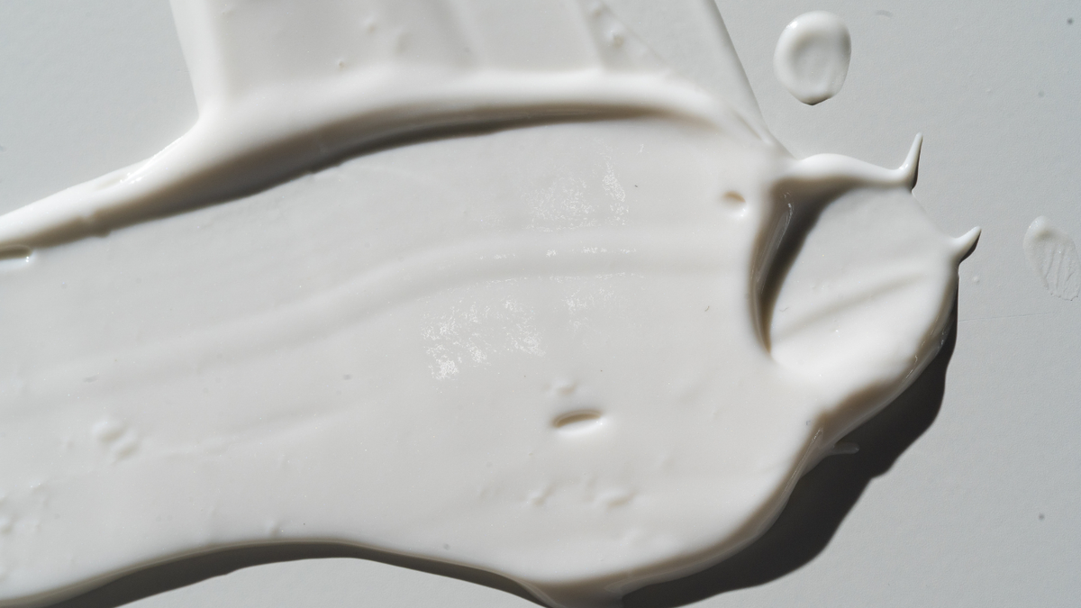 Thick spread of white face cream texture photographed in close-up with soft lighting
