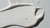 Thick spread of white face cream texture photographed in close-up with soft lighting